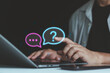© MUNTHITA - Business professional using a laptop with glowing question mark icons, illustrating online questions, customer support, problem solving, digital communication, uncertainty, and information search.