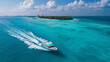 © MDRAFIQUL - Modern yacht cruising across vibrant turquoise tropical waters near lush green island paradise for summer travel luxury.