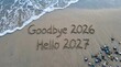 © Al Amin - Goodbye 2026 and Hello 2027 written in the sand on a tropical beach at sunset