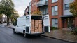 © Felipe - White delivery van with open back doors filled with cardboard boxes parked outside apartment building
