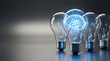 © AyamJago - Conceptual Image of Glowing Blue Human Brain Inside a Light Bulb Standing Out from a Row of Ordinary Bulbs Representing Artificial Intelligence, Creative Idea, Innovation and Mental Power