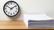 © Oleksandr - Large wall clock marks passage of time over neat stack of white documents. This composition represents pro workload management and approaching project deadlines in office or academic setting.
