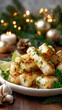 © syhin_stas - Cuban yuca con mojo on a festive holiday table with sparkling lights, pine branches, and white candles, presenting a traditional dish for christmas celebrations