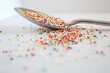 © Rachel - Colorful Rainbow Sprinkles in Spoon on White Background