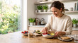 © diah - Home kitchen breakfast scene with woman preparing yogurt bowl topped with fruit granola and avocado for nutritious morning meal prep