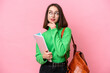 © luismolinero - Young student Ukrainian woman isolated on pink background looking up while smiling