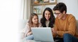 © HaJung - A family browsing trip planner apps on a laptop, discussing their travel itinerary together with excitement and joy for upcoming adventures, Room for added text