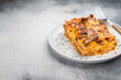 © Mironov - Traditional Italian lasagna bolognese with beef pasta and baked cheese portion on plate clean food background