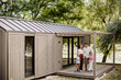 © BGStock72 - Family enjoying a sunny day outside their modern cabin by the lakeside