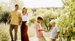 © BGStock72 - Family enjoying a sunny day picking grapes in a vineyard