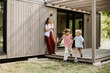 © BGStock72 - Joyful moments shared among family by the modern cabin near the lake