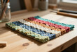 © stefanholm - Extreme close-up of colorful loom bands and felt texture in a studio.