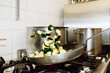 © Igor/Stocksy - Flambé in frying pan