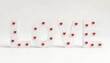 © bestphoto - Large white wooden letters spelling love decorated with small red hearts
