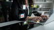 © InfiniteFlow - A focused professional works on tax preparation at a modern desk, utilizing digital tools and visual graphics to manage financial documents effectively. Cyphers