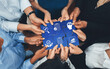 © InfiniteFlow - Diverse corporate officer workers collaborate in office, connecting puzzle pieces to represent partnership and teamwork. Unity and synergy in business concept by merging jigsaw puzzle. Concord Amity