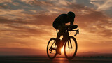 Triathlete riding his bicycle during sunset, preparing for a marathon. The warm colors of the sky provide a beautiful backdrop for his determined and focused effort.