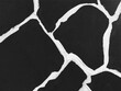 © AgusSaid - Abstract black and white mosaic pattern background with thick white lines on black surface.