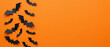 © helllo - Black Halloween bats flying on orange background with copy space
