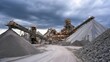 © 69 - Industrial mining site with conveyor belts transporting gravel and large piles of raw material under a cloudy sky