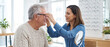 © Rohan Katwe - Optometrist fitting prescription eyeglasses for mature patient