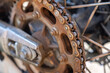 © Dylan - Close up of a chain and sprocket on a motorcycle