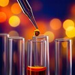 © Akbar - A close-up view of a drop of liquid falling from a pipette into a test tube.