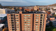 © Amazing Aerial - Aerial view of a multi-story brick residential building with balconies, surrounded by the urban cityscape of Reading during autumn, Reading, Pennsylvania, United States.