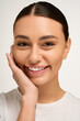 © LIGHTFIELD STUDIOS - Young woman showcasing her beauty and style with a radiant smile against a neutral backdrop