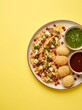 © NAZNIN - Delicious Indian street food dahi puri served on a plate with chutneys
