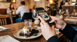 © Alodie - Person slicing chocolate cake with knife in restaurant.