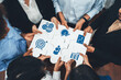 © InfiniteFlow - Diverse team members collaborate using puzzle pieces that represent key business concepts and performance metrics, symbolizing synergy and effective teamwork in a corporate setting. Amity