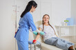 © Pixel-Shot - Blood donation and medical screening, nurse preparing young woman for blood draw in clinic with intravenous equipment and heart shaped stress ball