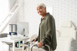 © Pixel-Shot - Healthy aging and senior mobility, elderly woman using a walker for physical rehabilitation in a medical office or clinic for patient care support