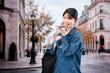 © maroke - 海外旅行をしながらAIで調べ物をする若い女性