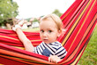 © Westend61 - Little girl sitting in hammock