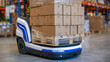 © Maksym Tereshchenko - Heavy duty self-driving warehouse robot transporting a towering stack of uniform cardboard boxes, broad low cargo platform supporting the load, cartons evenly aligned and wrapped in clear stretch fi