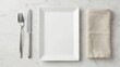© ART BY TAMANNA - Empty rectangular white plate with cutlery and linen napkin on a marble table. Perfect top-down view for restaurant menu design and food presentation concepts.