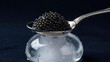 © AiGalaxy - Caviar piled on a silver spoon above a glass jar. Gourmet delicacy and luxury food ingredient. Fine dining cuisine and upscale restaurant menu. Seafood appetizer for elegant entertaining.