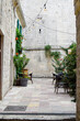 © ADDICTIVE STOCK - Historic stone alley with cafe terrace and string lights