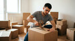 © Lua - Man packing cardboard boxes with tape gun for moving house
