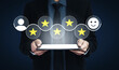 © InfiniteFlow - A businessman presents a tablet featuring review stars and smiley icons, symbolizing customer satisfaction. This image reflects the importance of feedback in business performance. Ledger