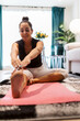 © ADDICTIVE STOCK - Woman practice yoga stretch on mat in living room