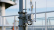 © photo for everything - Industrial wireless communication antenna device mounted securely on metal pole structure outdoors against bright daylight sky background