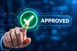 © ReponChandra - A professional businessman touching a glowing digital interface button with an approved checkmark symbol, representing success, quality control, and business validation.