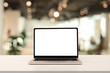 © chinnarach - close up isolated on blank white screen display of laptop computer on table inside office room for add content of design banner , website or template or online shopping e-commerce concept