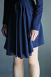 © schankz - Dark blue dress with a soft, flowing silhouette. Model wears long sleeves and a mid-thigh length skirt.