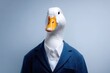 © Marina Demidiuk - Cool surreal character with goose bird head on businessman body wearing formal suit tie against plain blue background. Creative corporate humor, conceptual social media content. SEO Boss chief. Blog