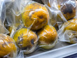 © CoreRock - Vacuum sealed ripe passion fruit with yellow and orange skin arranged in chilled market display, showing fresh tropical produce ready for sale and careful food packaging