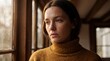 © Giga - Thoughtful young woman with freckles wearing a turtleneck sweater looking out a rainy window with thoughtful expression wears
